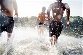 Photo of people running through water