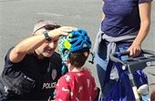 Child being fitted for a bike helmet