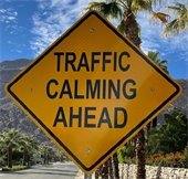 Street sigh that reads traffic calming