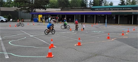 Children riding bikes in an obstacle course