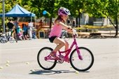 Girl riding a bike at a bike rodeo